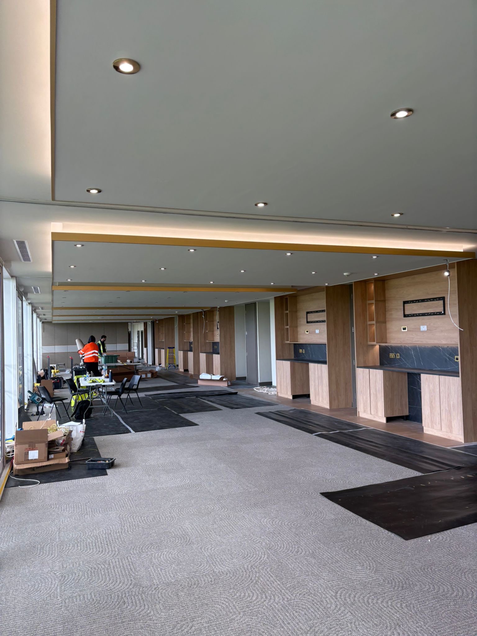 Office hospitality area mid fit-out with painters working