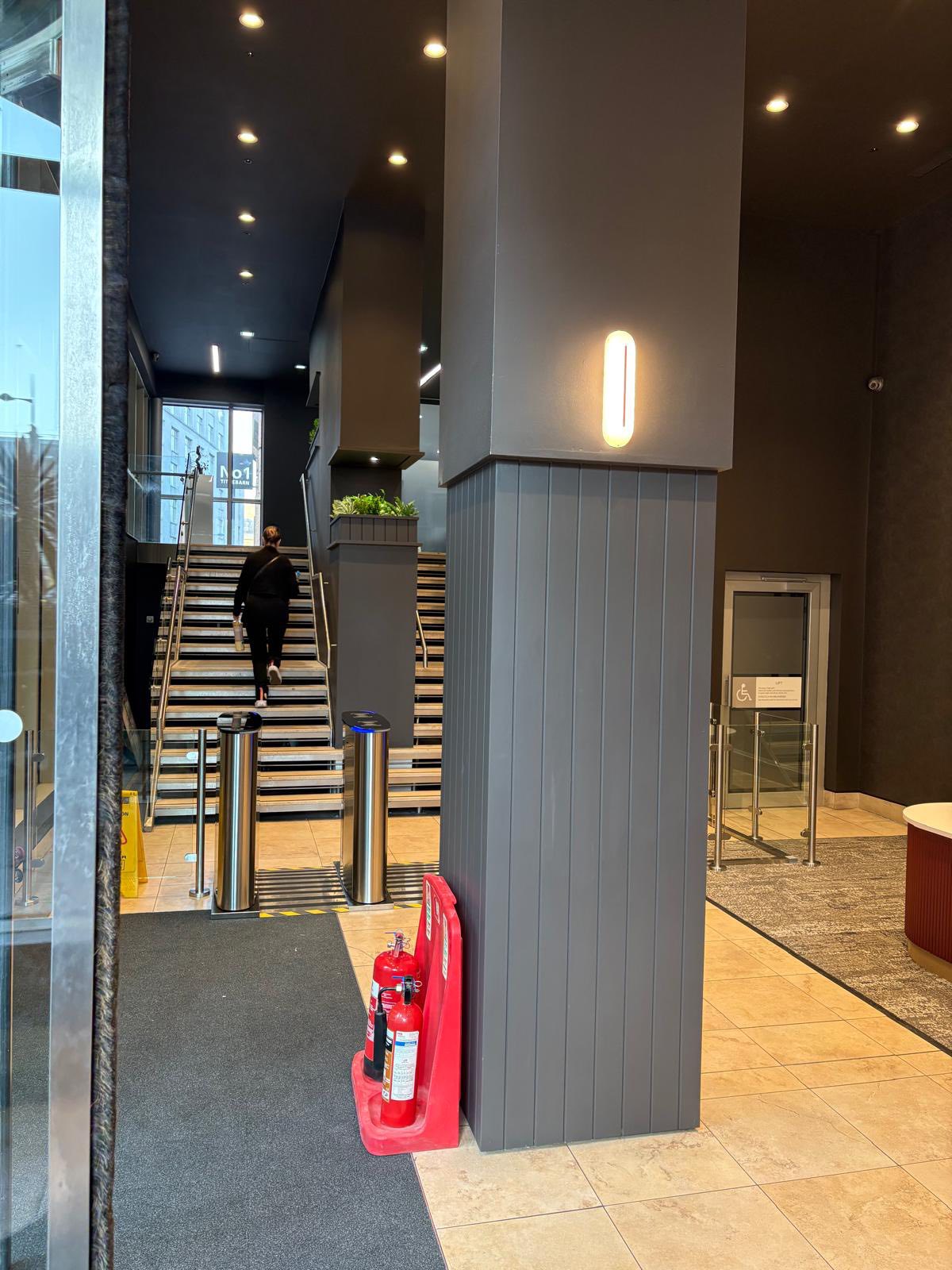 Commercial entrance with anthracite columns and clean walls